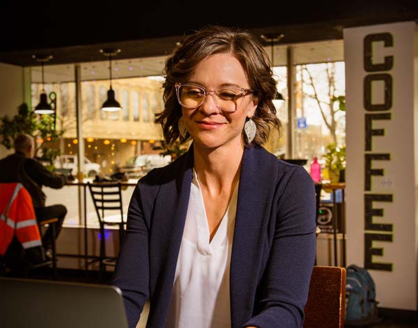 Bethany Colaprete – EdS, NCC, LPC/LMHC in a coffee shop